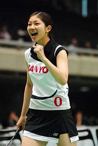 Reiko Shiota celebrating on badminton court.