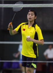 Wang Lin in yellow badminton uniform.