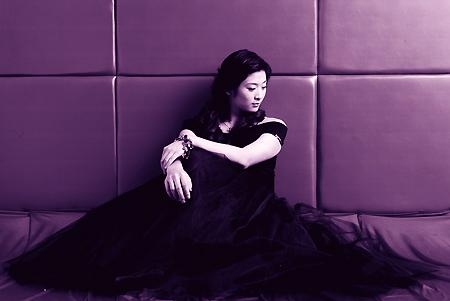 Studio shot of Wang Lin in a black dress.