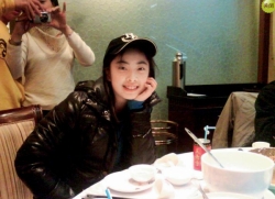 Wang Shixian in a hat and leather jacket.
